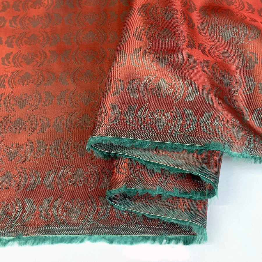 E210 Mirrored Red Pale Green Mirrored Leaf Design Pattern Lining Fabric Close Up Fabric Photo