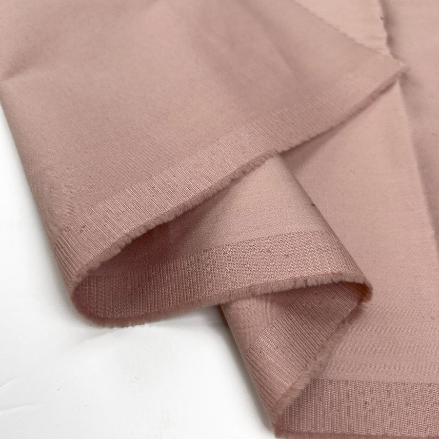 Ego pink cotton elastane stretch woven italian deadstock trouser fabric fold