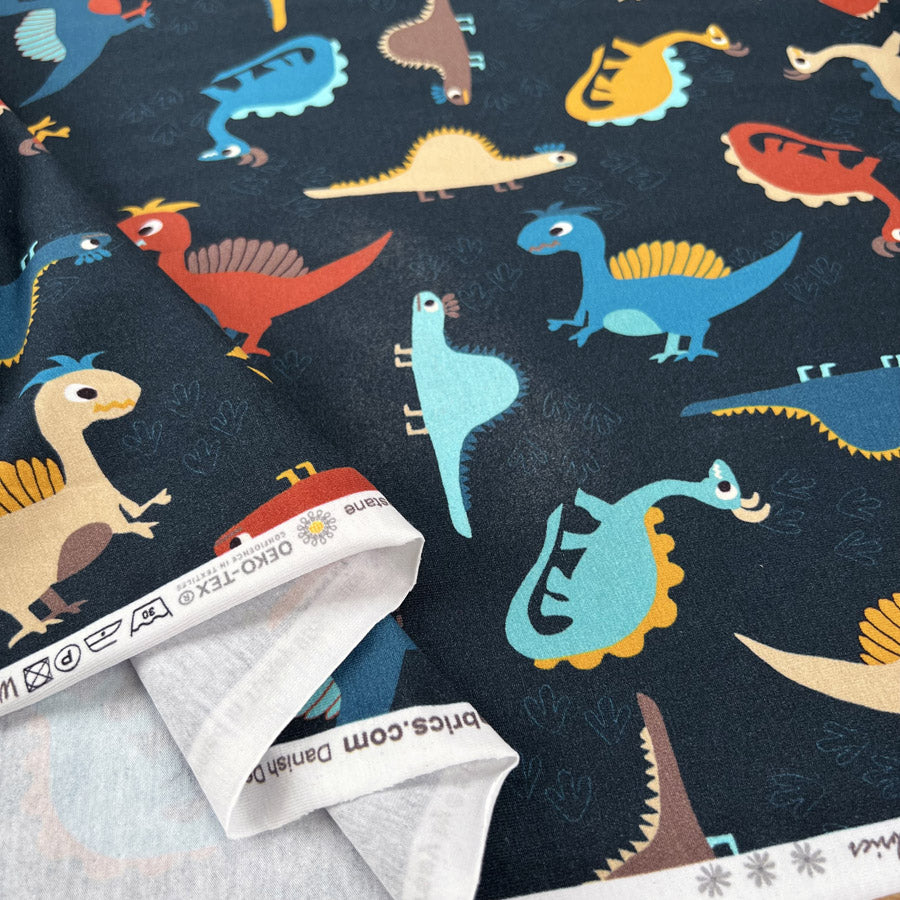 Stof cotton jersey chompers dinosaur print navy oeko tex elastane knitted fabric fold