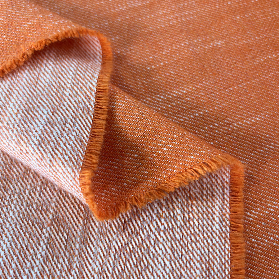 Tangerine Dream Orange White Polyester Cotton Viscose Trousering Fabric Fold