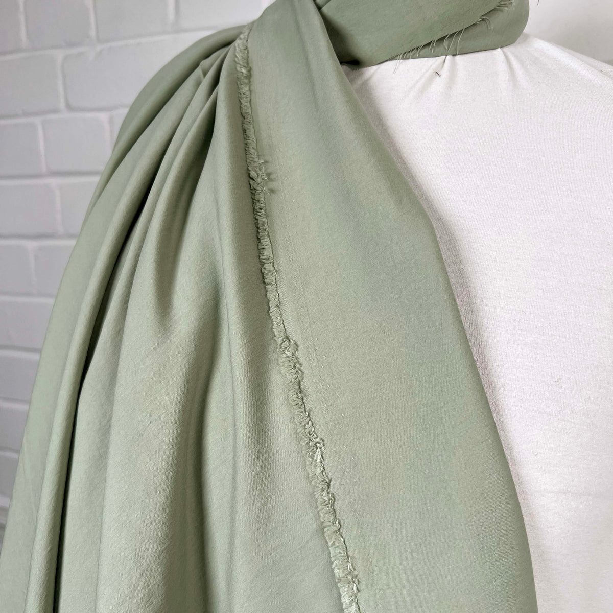 Gentle Green Modal Recycled Polyester Dress Fabric Hang