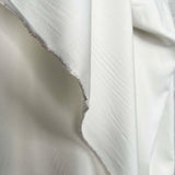 La Dolce Viscose Plain Woven Cream Ex Designer Deadstock Shirting Fabric Fold
