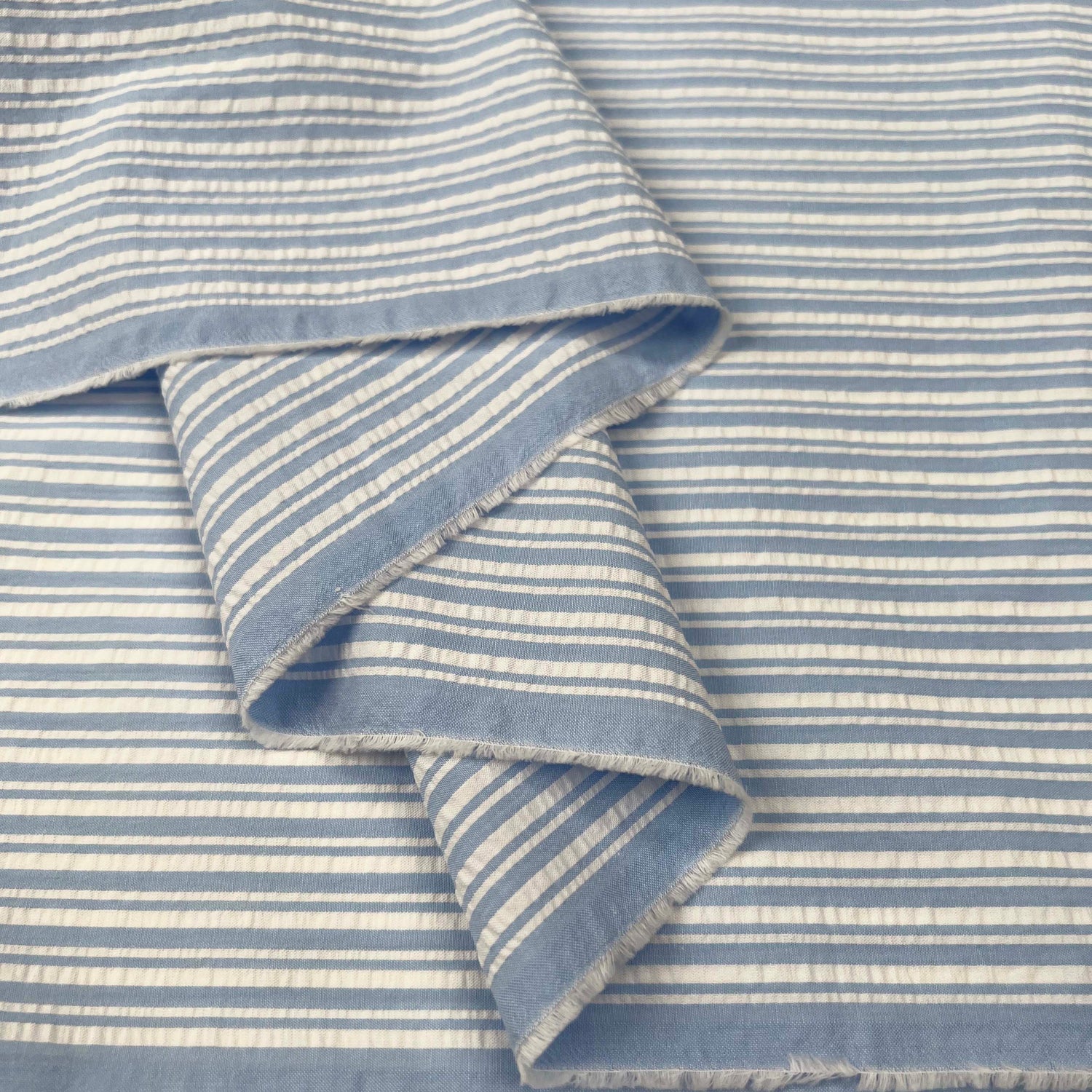 Proper Seersucker Pale Blue Stripe Cotton Fabric Fold