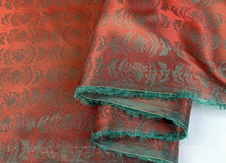 E210 Mirrored Red Pale Green Mirrored Leaf Design Pattern Lining Fabric Close Up Fabric Photo