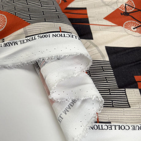Italian Tencel Cycle Twill Orange Black Cream Bike Print Deadstock Dress Fabric Fold