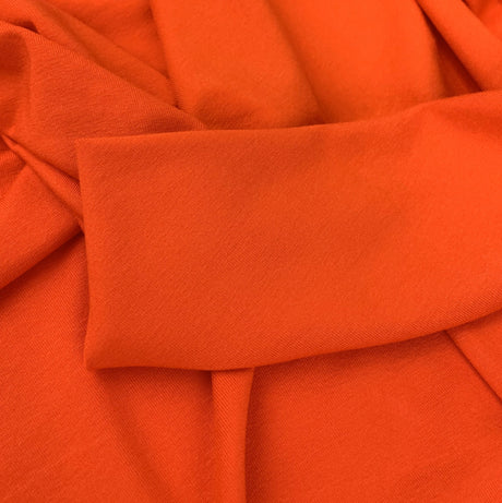 Spongle Orange Knitted Bright Viscose Lycra Jersey Fabric Close Up Dress Fabric Photo